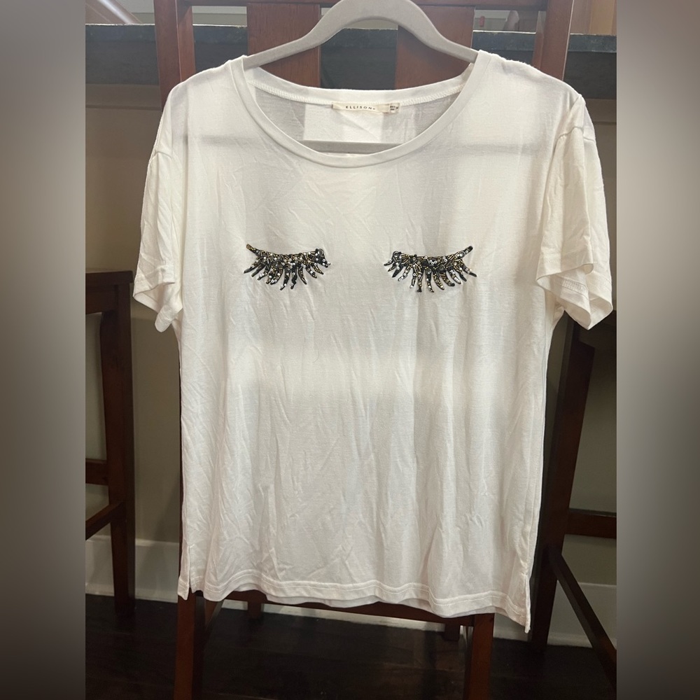 White soft tee with black and gold beaded eyelashes